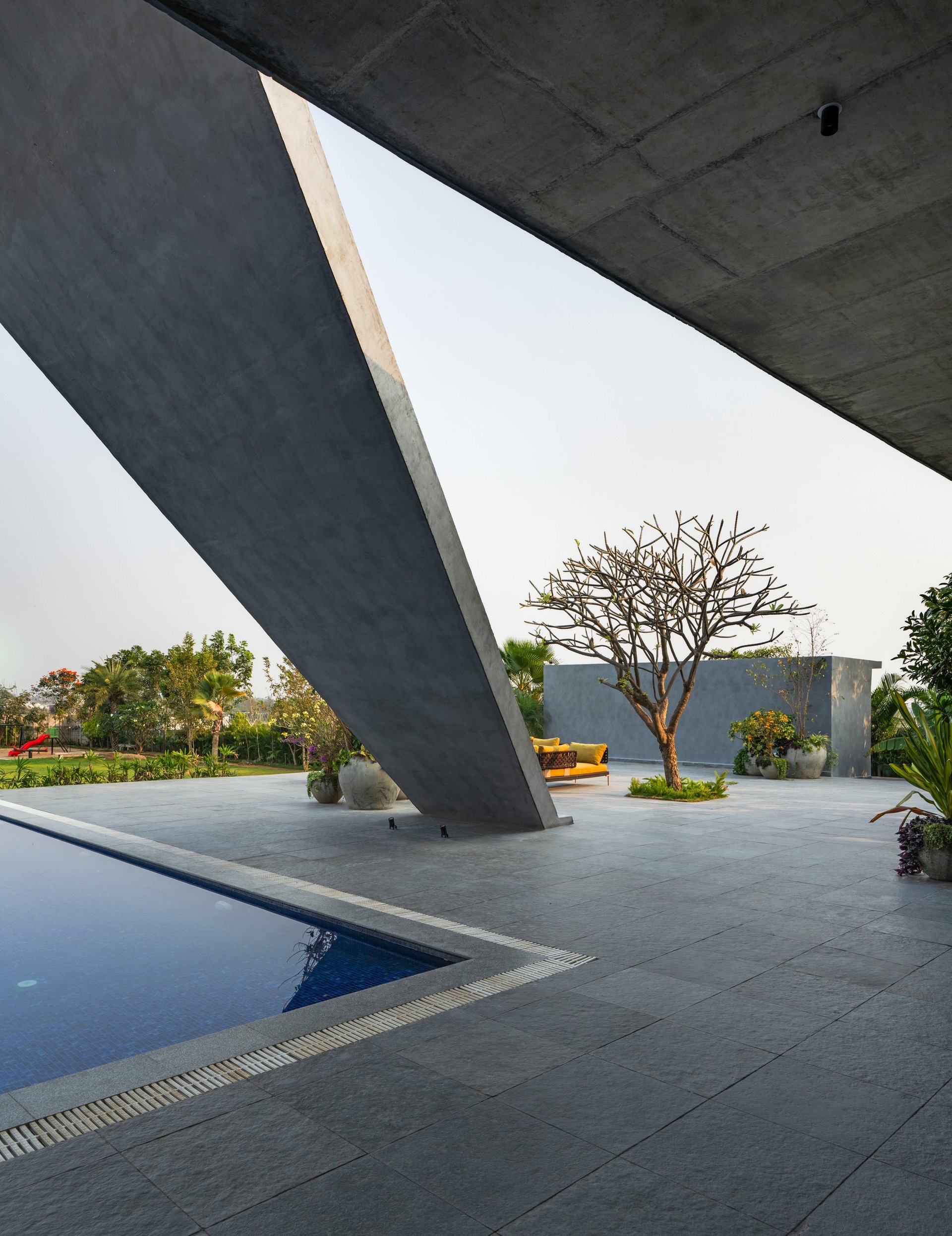 The swimming pool at SAHN at dusk, reflecting the house