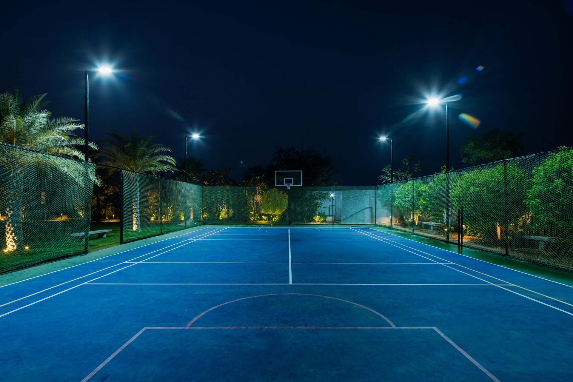 The lawn-tennis court at SAHN lit at night